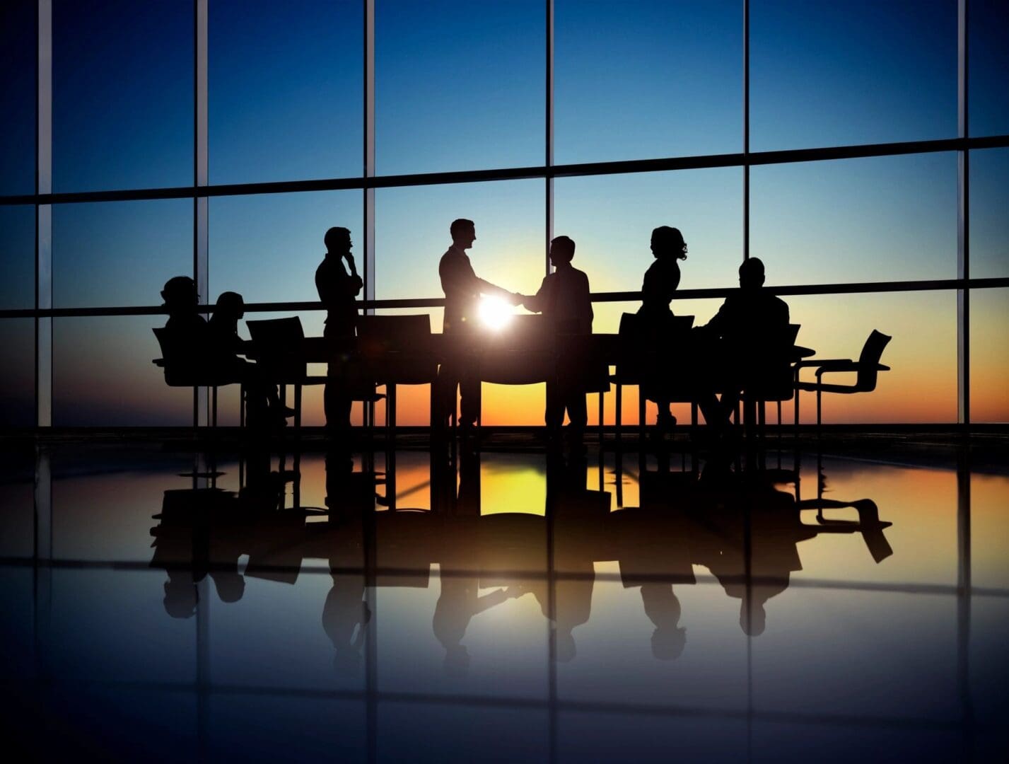 A group of people sitting around a table.