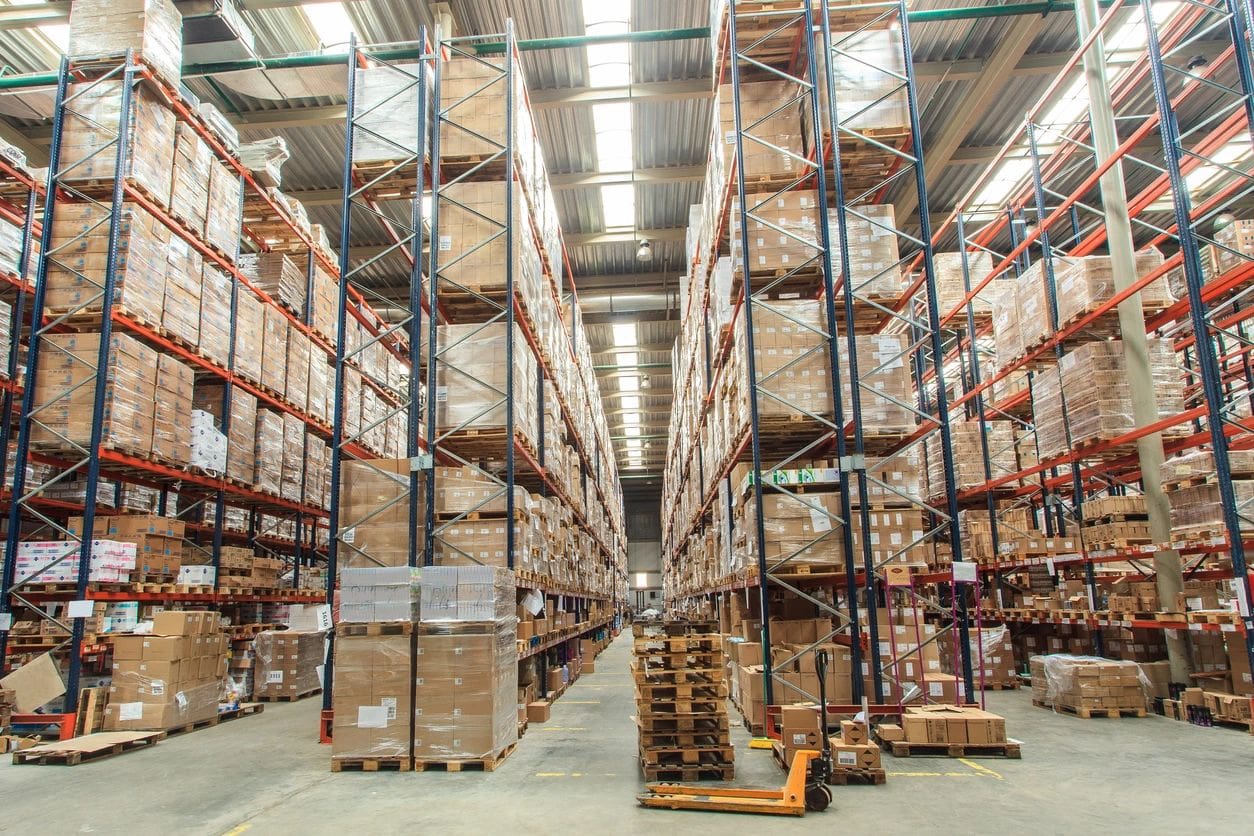 A warehouse filled with lots of boxes and pallets.